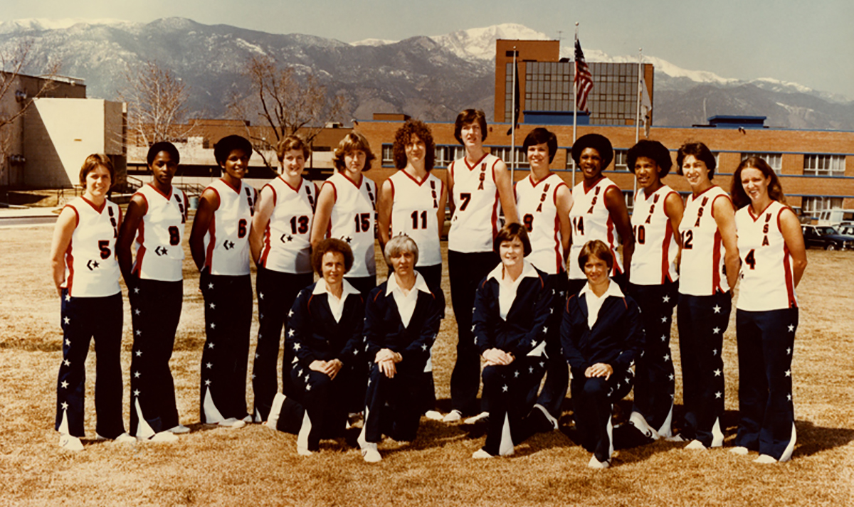         Description: A women's basketball team posing in front of a mountain.