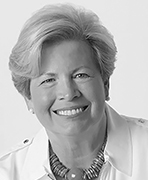 A black and white photo of a woman smiling.