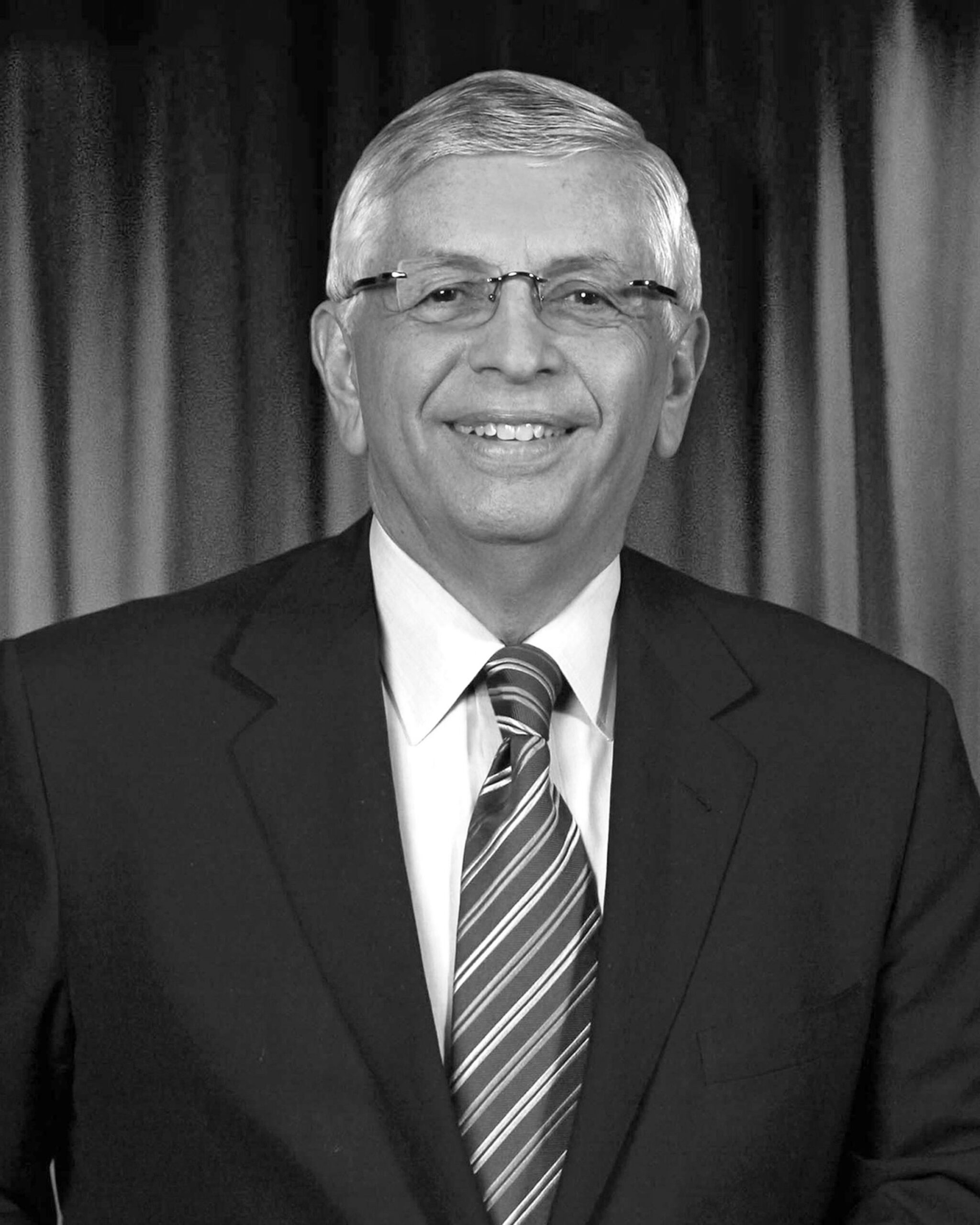 A black and white photo of a man in a suit and tie.