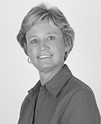 A black and white photo of a woman in a shirt.