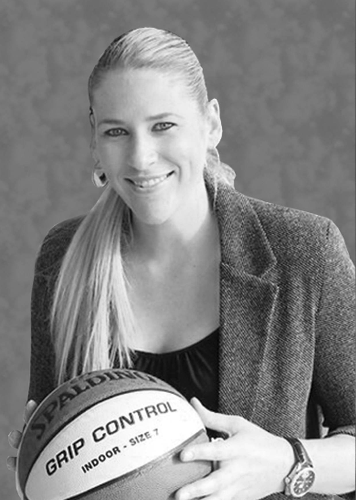 A black and white photo of a woman holding a basketball ball.