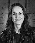 A black and white photo of a woman smiling.