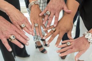 A group of people adorned with Baron rings on their hands.