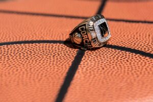 A basketball ring sits on top of a basketball court.