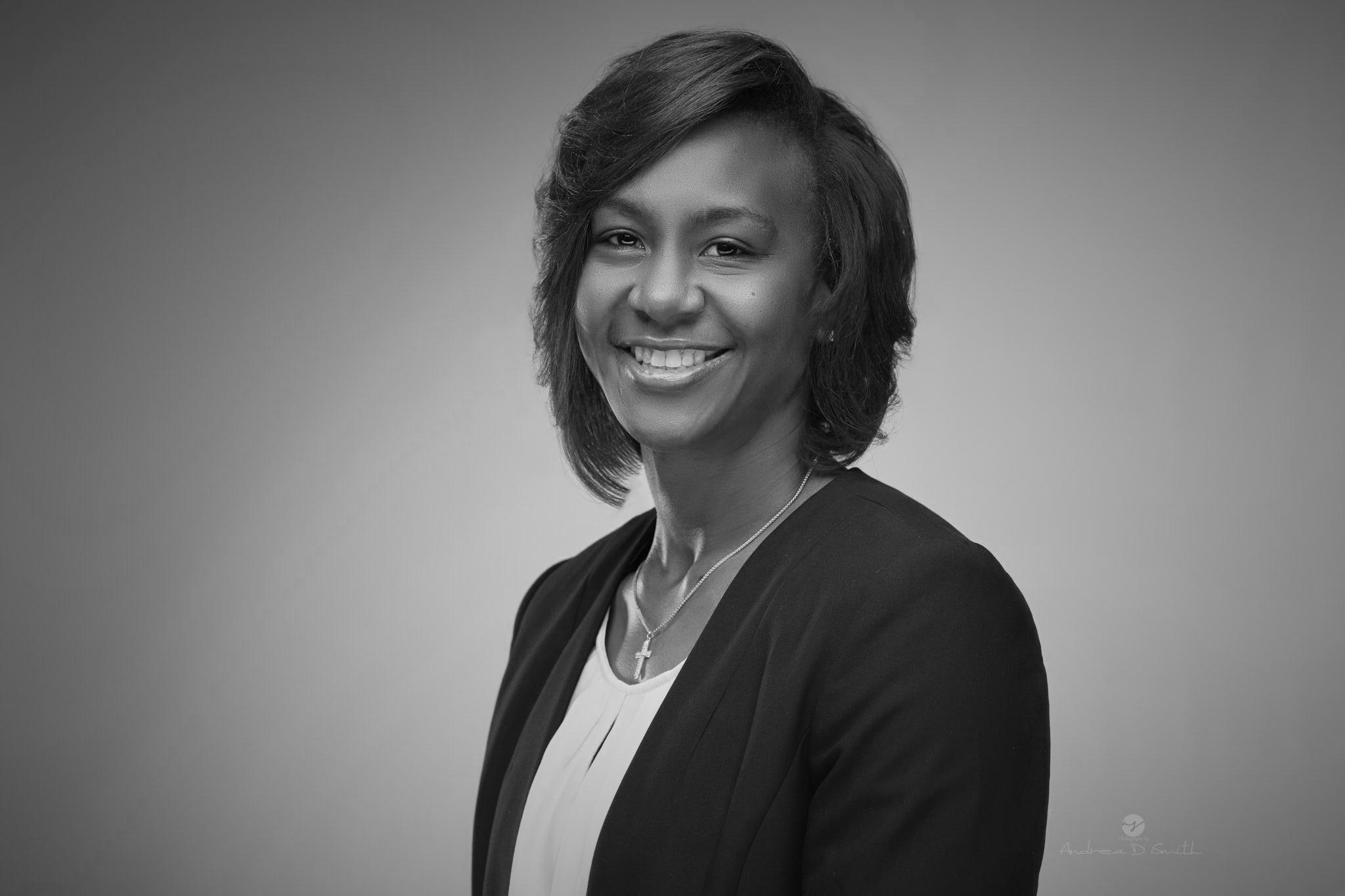 A black and white photo of a woman smiling.