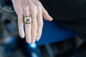 A woman in a wheelchair wearing a ring.