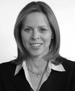 A black and white photo of a woman in a business suit.