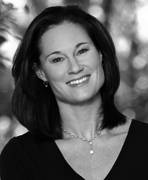 A black and white photo of a woman smiling.