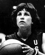 A black and white photo of a woman holding a basketball.