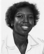 A black and white photo of a woman holding a tennis racket.