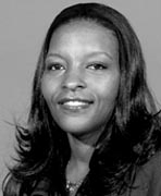 A black and white photo of a woman smiling.