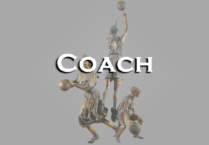 A bronze statue of a coach holding a basketball.