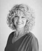 A black and white photo of a woman with curly hair.