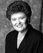 A black and white photo of a woman in a suit.