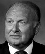 A black and white photo of a man in a suit.