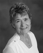 A black and white photo of an older woman smiling.