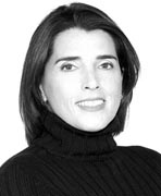 A black and white photo of a woman in a turtle neck sweater.