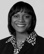 A black and white photo of a woman smiling.