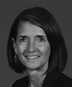 A black and white photo of a woman smiling.