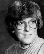 A black and white photo of a woman wearing glasses.