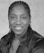 A black and white photo of a woman with dreadlocks.