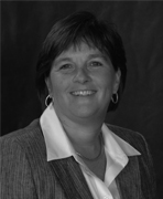 A black and white photo of a woman smiling.