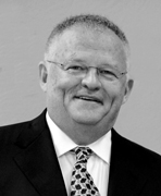 A black and white photo of a man in a suit and tie.