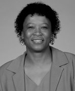 A black and white photo of a woman with curly hair.