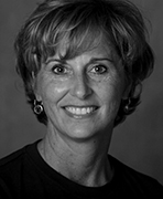 A black and white photo of a woman smiling.