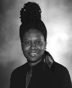 A black and white photo of a woman in a suit.