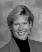 A black and white photo of a woman smiling.