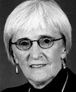 A black and white photo of an older woman with glasses.