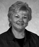 A black and white photo of an older woman smiling.