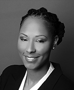 A black and white photo of a woman in a business suit.