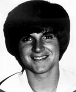 A black and white photo of a young man smiling.