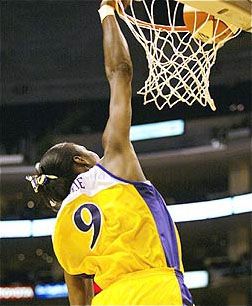 In the history of women's basketball, a skilled player leaps into the air and successfully dunks the ball.