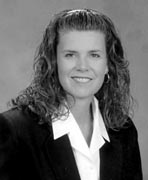 A black and white photo of a woman in a business suit.