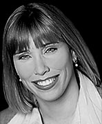 A black and white photo of a woman smiling, highlighting her remarkable presence as one of the women's basketball hall of fame members.