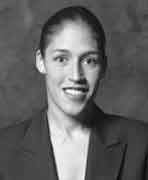 A black and white photo of a woman in a suit.