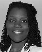 A black and white photo of a woman smiling.