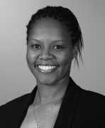 A black and white photo of a woman smiling.