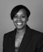 A black and white photo of a woman in a business suit.