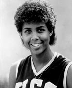 A black and white photo of a woman in a basketball uniform.