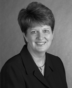 A black and white photo of a woman in a suit.