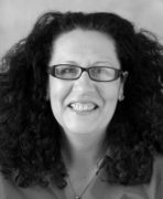 A black and white photo of a woman with curly hair.