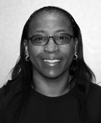 A black and white photo of a woman wearing glasses.