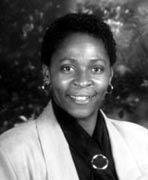 A black and white photo of a woman smiling.