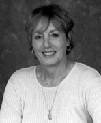 A black and white photo of a woman smiling.