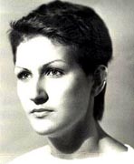 A black and white photo of a woman with short hair.