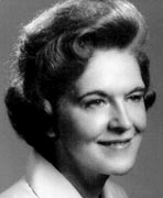 A black and white photo of a woman smiling, who is also a member of the women's basketball hall of fame.